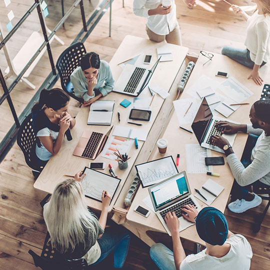 pohled shora na kolegy za stolem v zasedací místnosti