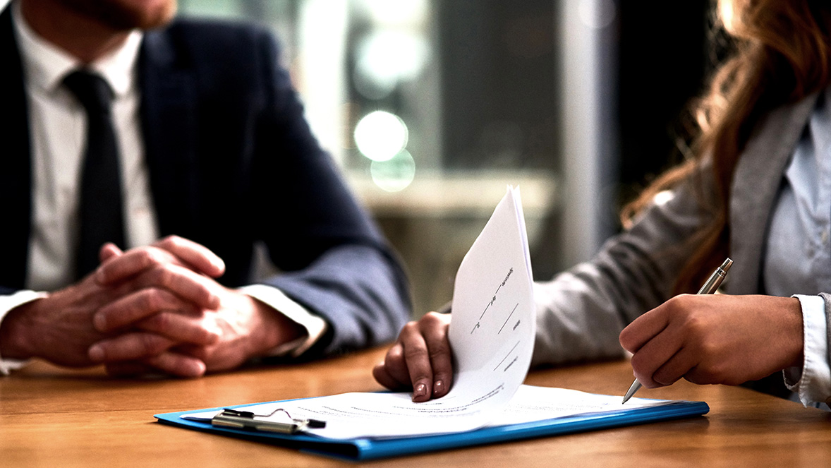 kolegové na schůzce diskutují nad deskami s papíry