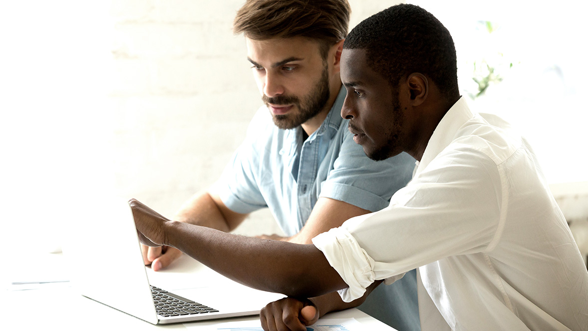 two colleagues working at a laptop