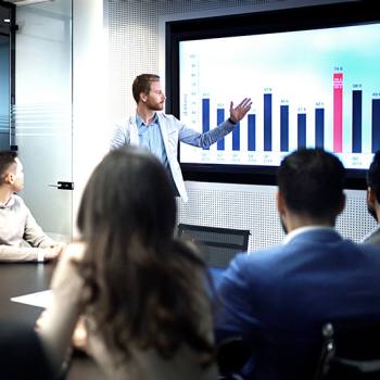 man showing graphs in a meeting